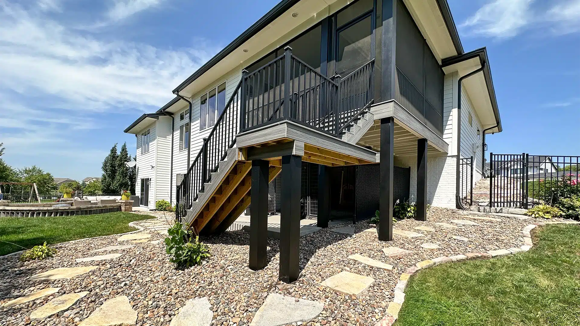 two story residential deck with black railing and column wraps