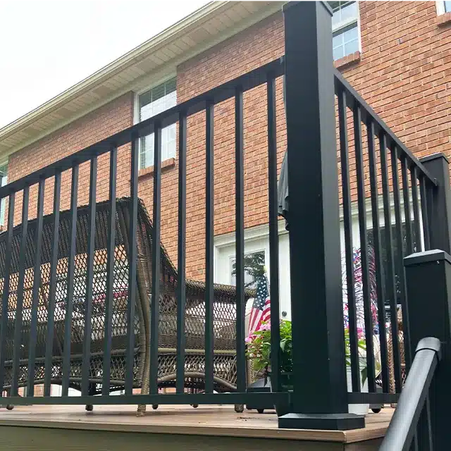 close-up shot of a corner post on a black deck railing system