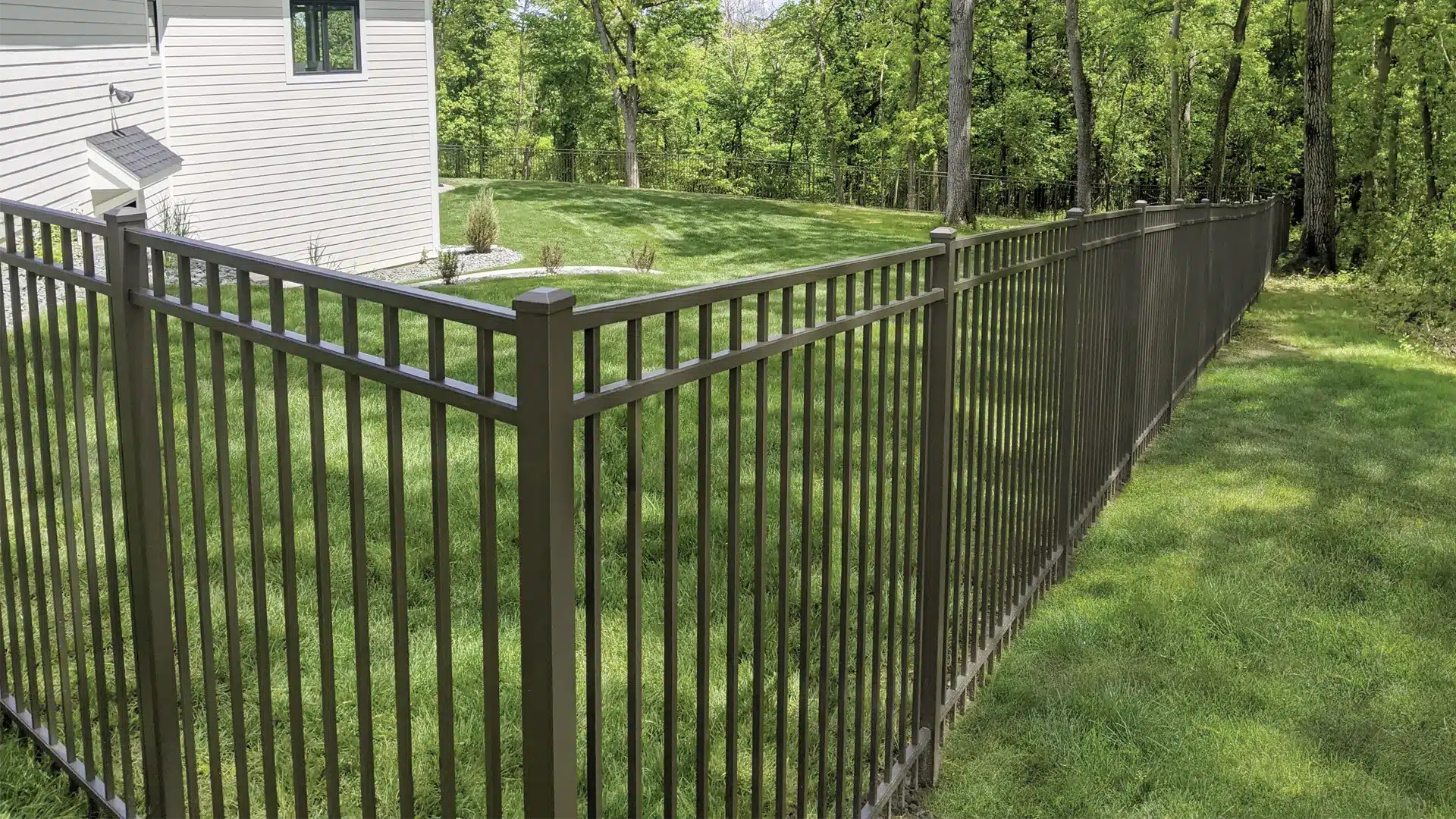 black aluminum picket fencing in a residential backyard