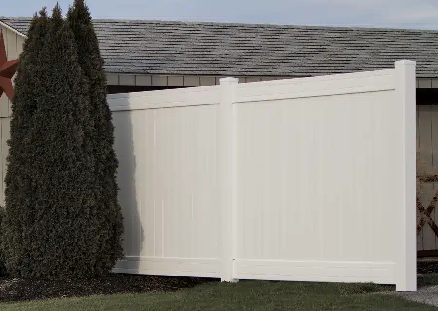 white vinyl privacy fence in residential backyard