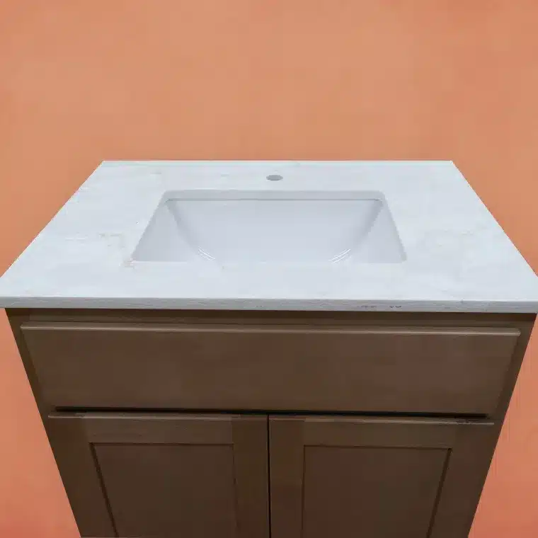 overview of smoked cashew stained cabinet with off white vanity top