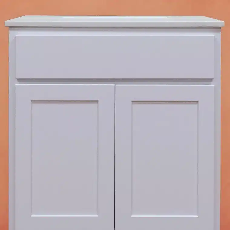 front side of white cabinet with cream vanity top