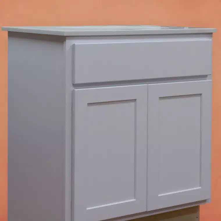 side view of smoked cashew stained cabinet with cream vanity top