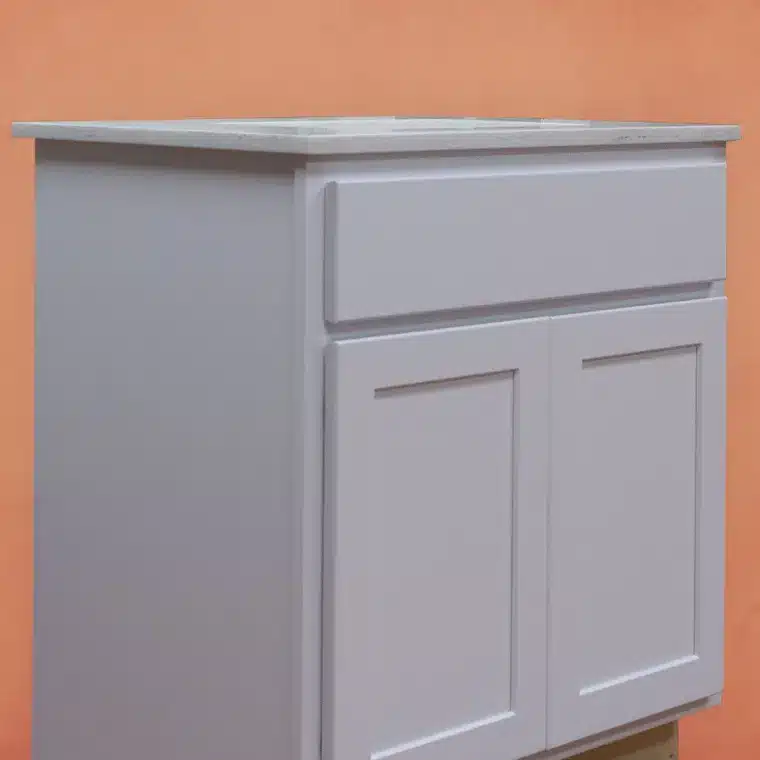 side view of white cabinet with off white vanity top